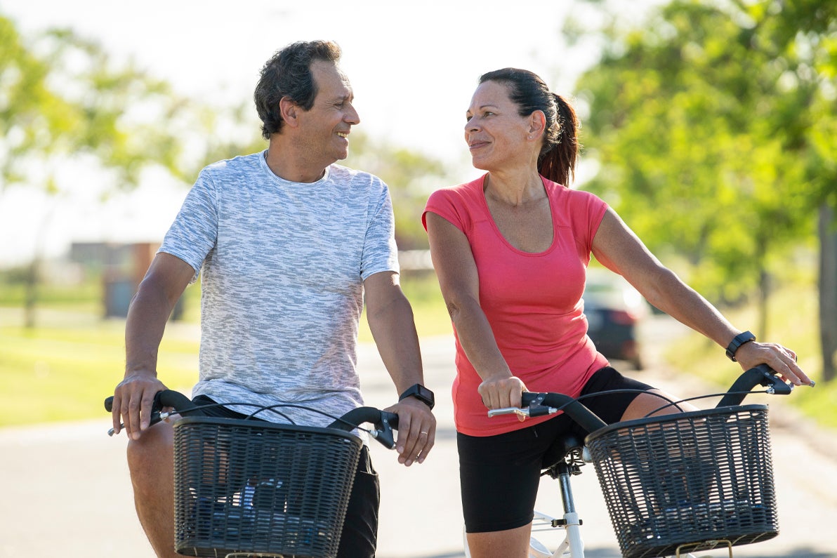 Couple riding bikes outside