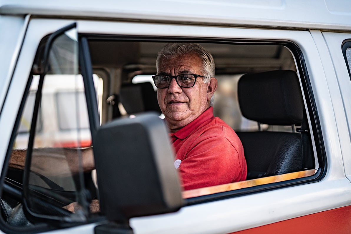 Man in truck with sunglasses looking out truck window